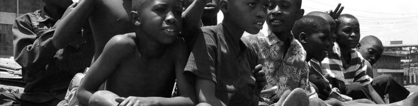 Children sitting packed during a Maji Mazuri event
